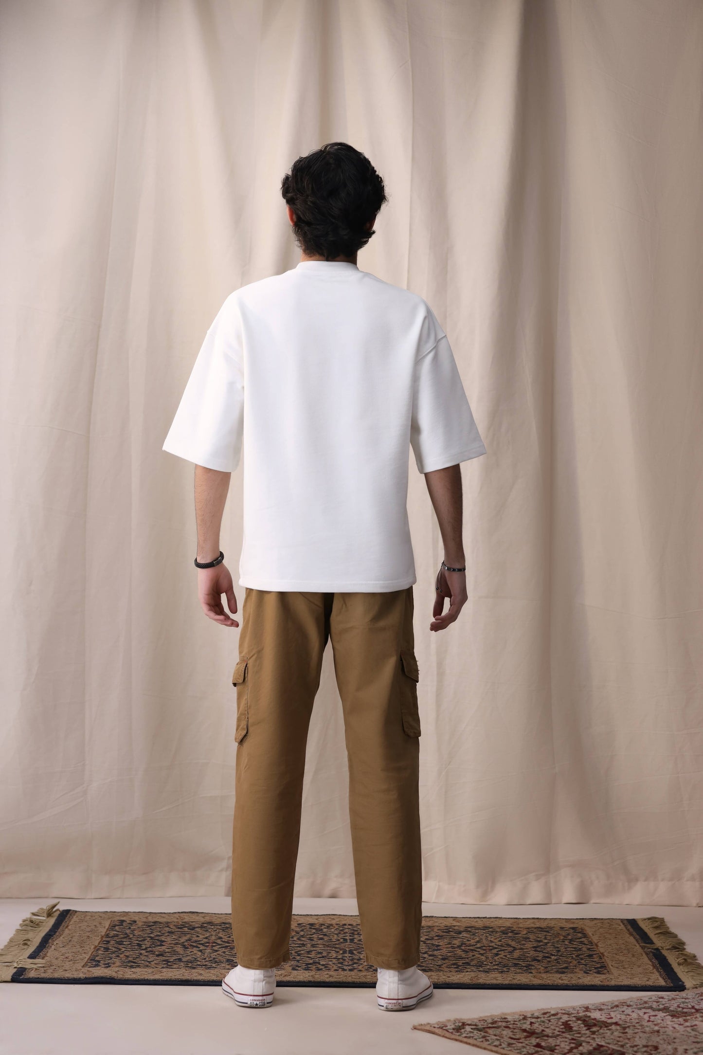 Model in Raah white oversized box fit unisex t-shirt by Shatrnj
