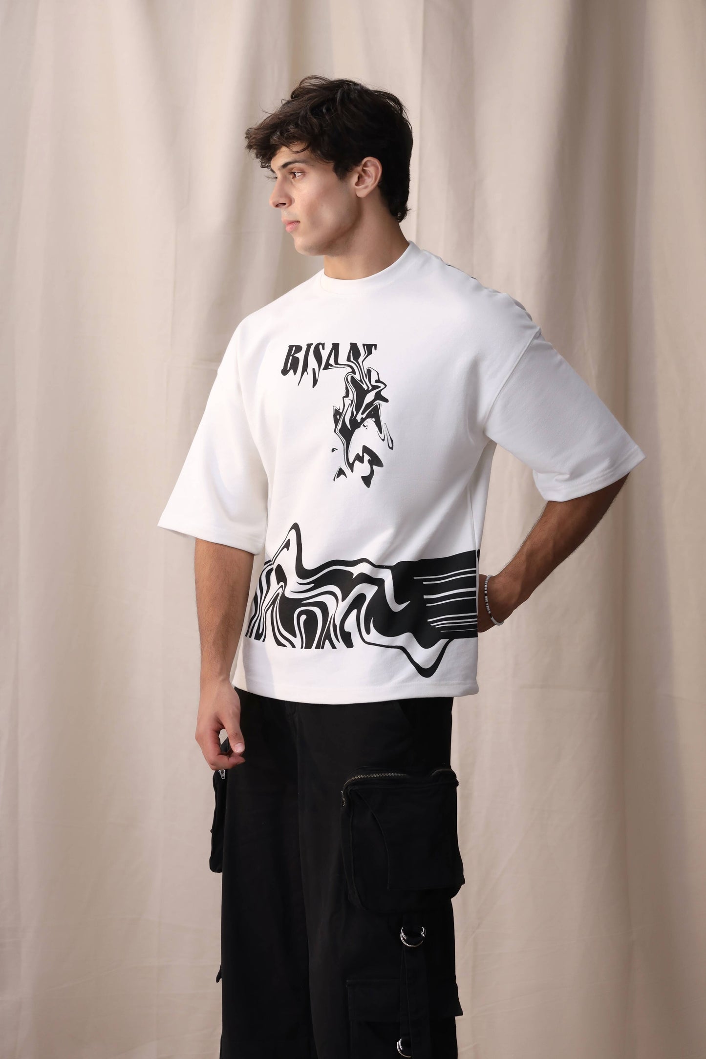 Model wearing Bisaat white oversized drop shoulder unisex t-shirt by Shatrnj