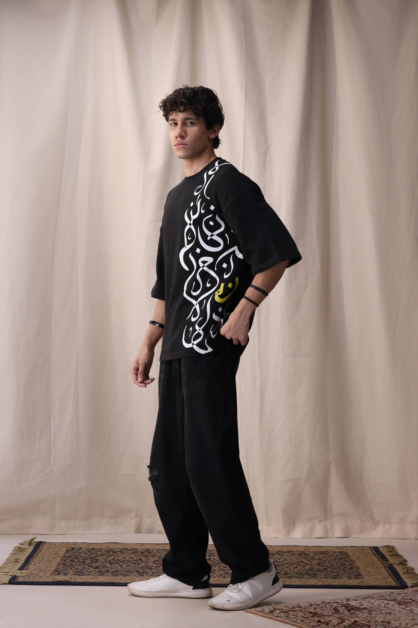 Model wearing Feral black oversized drop shoulder unisex t-shirt by Shatrnj