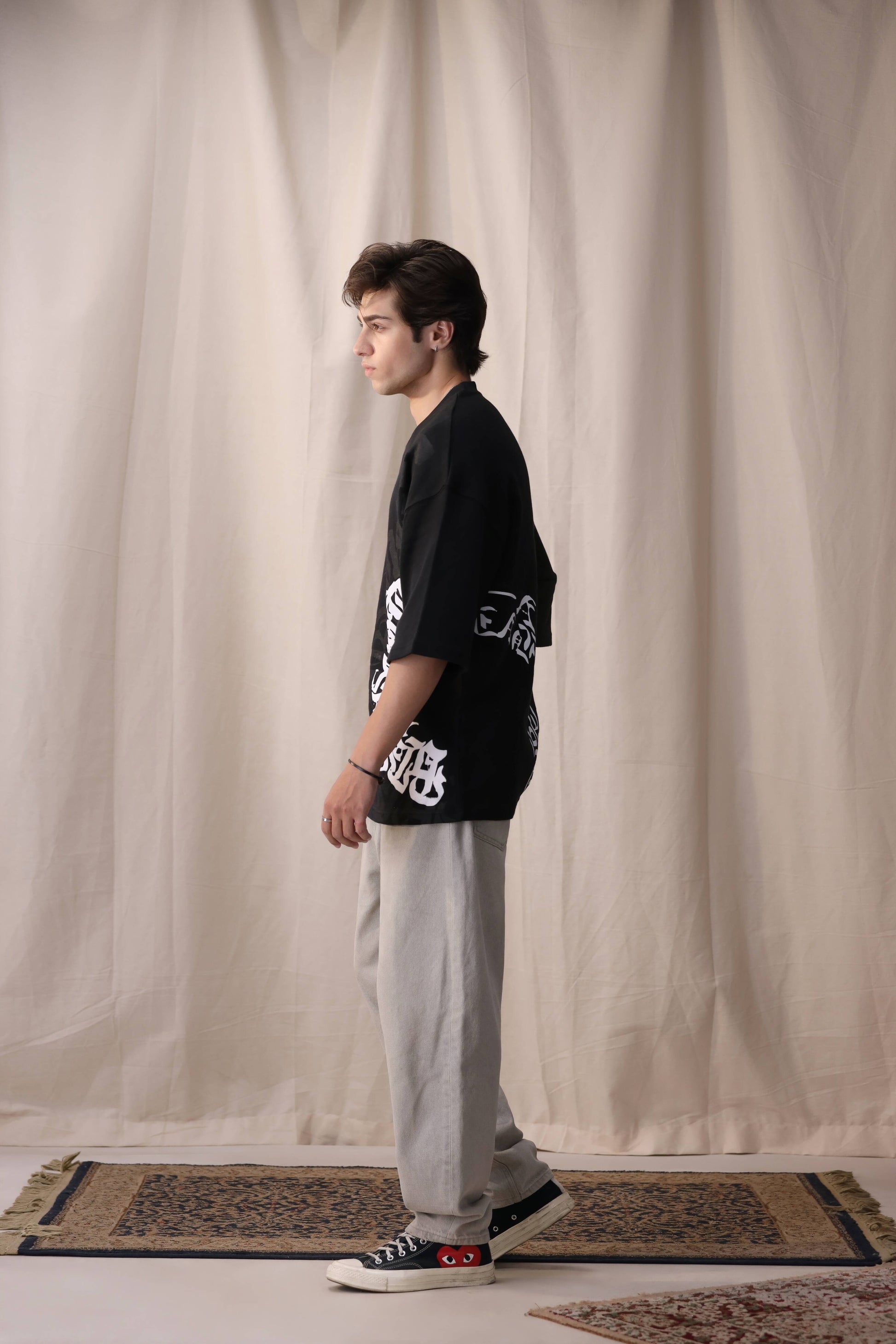 Model wearing Arkaan black oversized drop shoulder unisex t-shirt by Shatrnj
