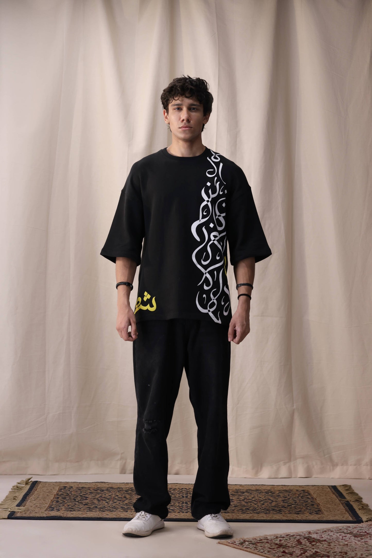 Model wearing Feral black oversized drop shoulder unisex t-shirt by Shatrnj