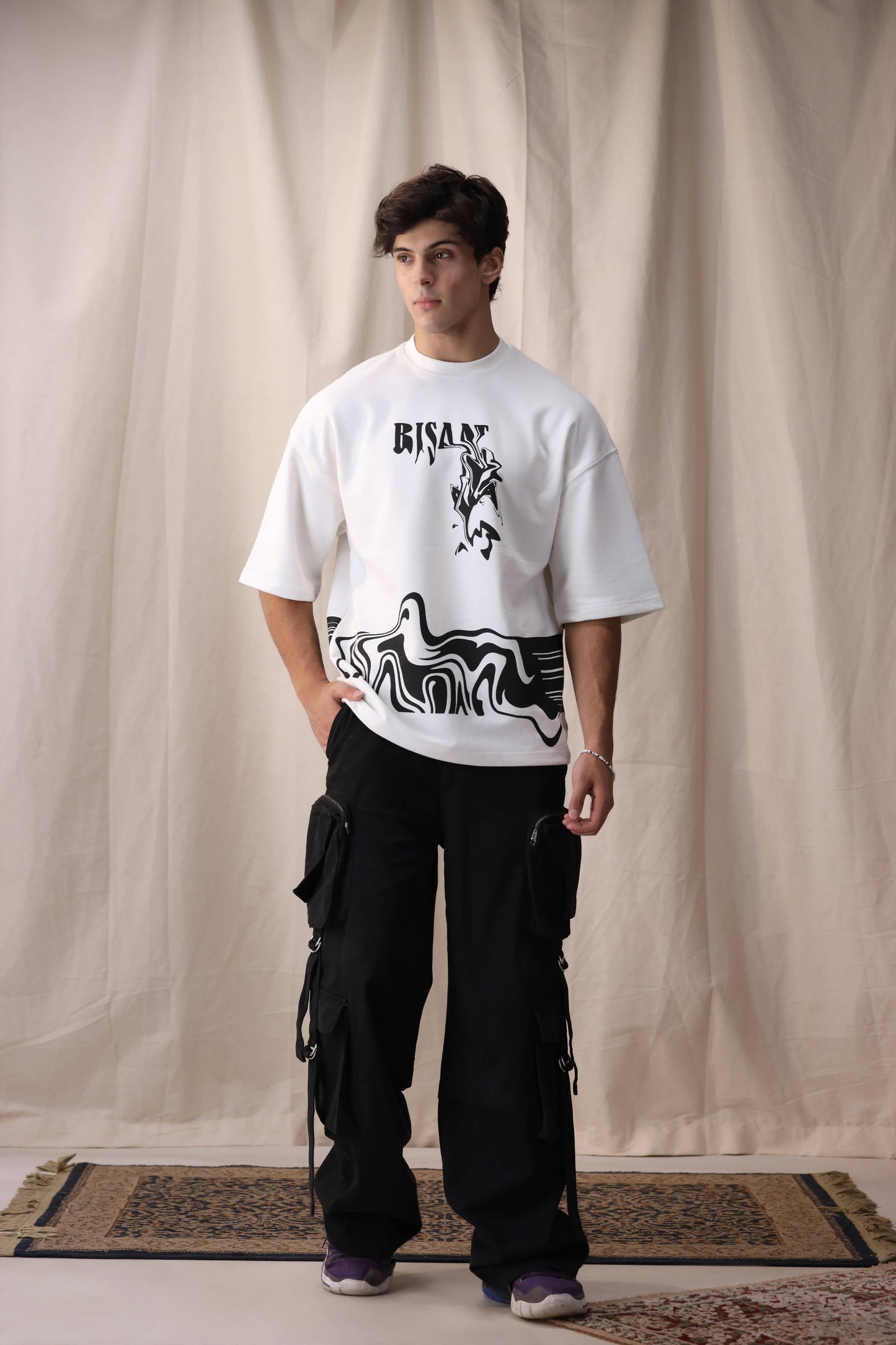 Model wearing Bisaat white oversized drop shoulder unisex t-shirt by Shatrnj