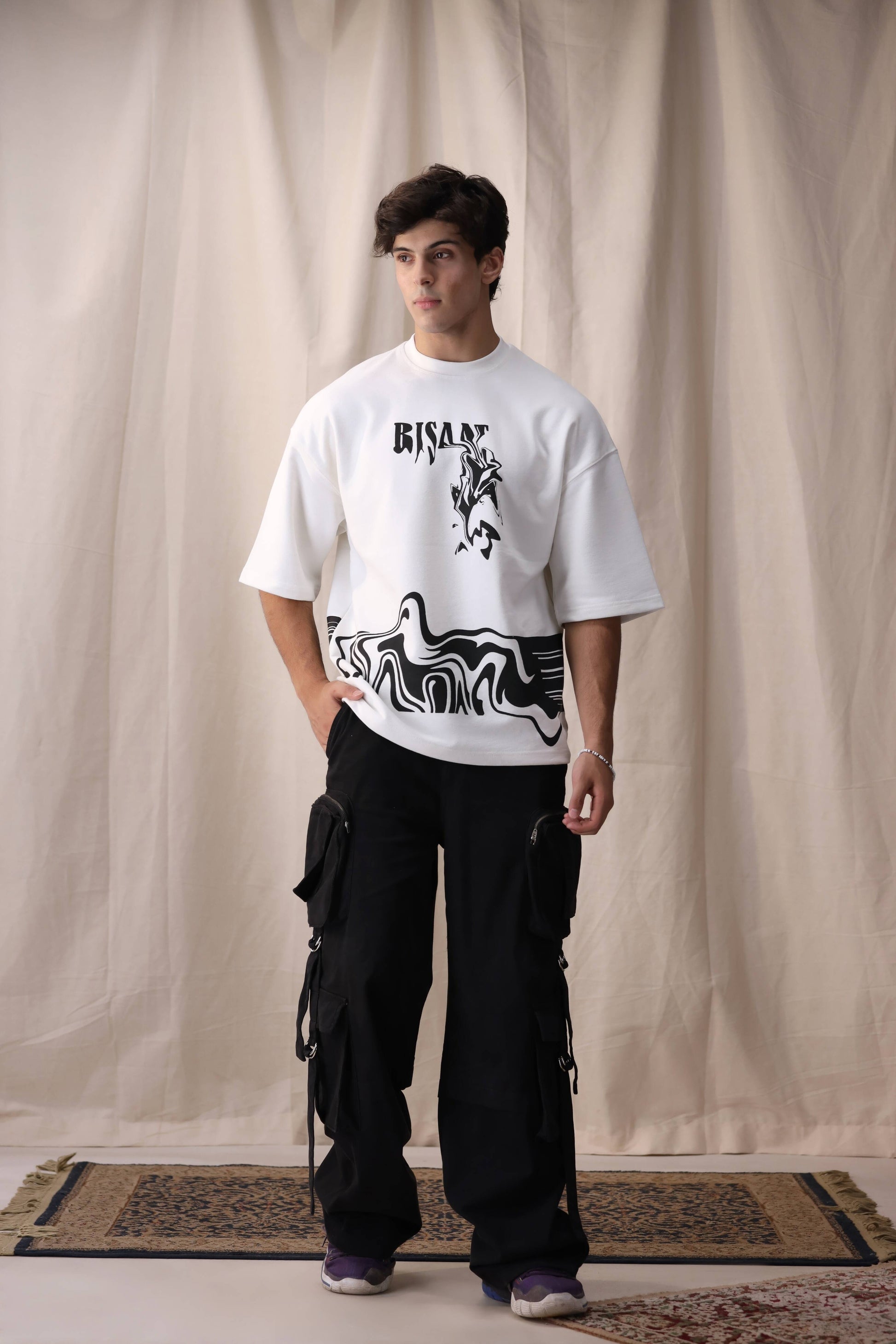 Model wearing Bisaat white oversized drop shoulder unisex t-shirt by Shatrnj